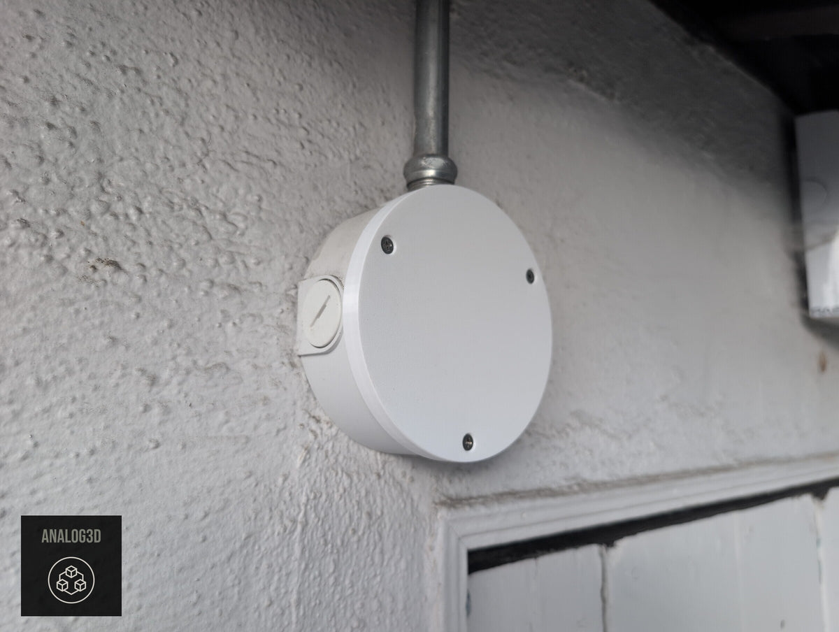 Blank cover plate installed on a Dahua PFA137 junction box, angled view (customer install photo)