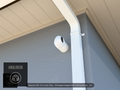 UVC-G5-Turret-Ultra 30 degree angled wall-ceiling mount (3in ext3) clearing a swan-neck downspout on stucco