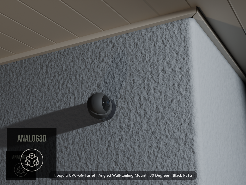 Ubiquiti UVC-G6-Turret angled wall mount in black PETG on a stucco wall at night