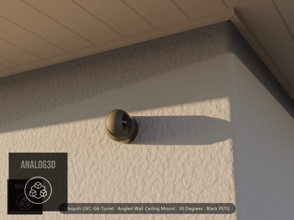 Ubiquiti UVC-G6-Turret angled wall mount in black PETG on a stucco wall at golden hour