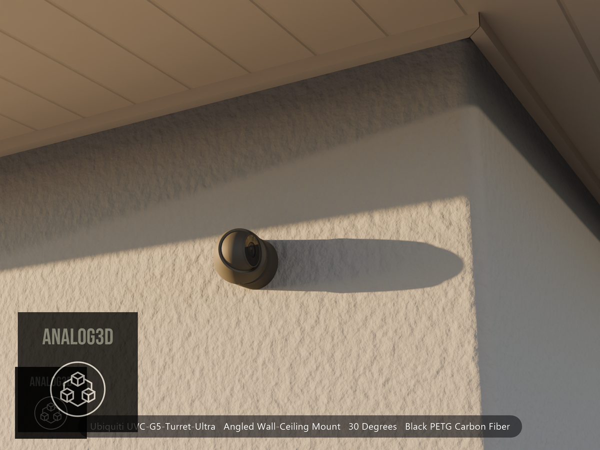 Ubiquiti UVC-G5-Turret-Ultra angled wall mount in black PETG carbon fiber on a stucco wall at golden hour