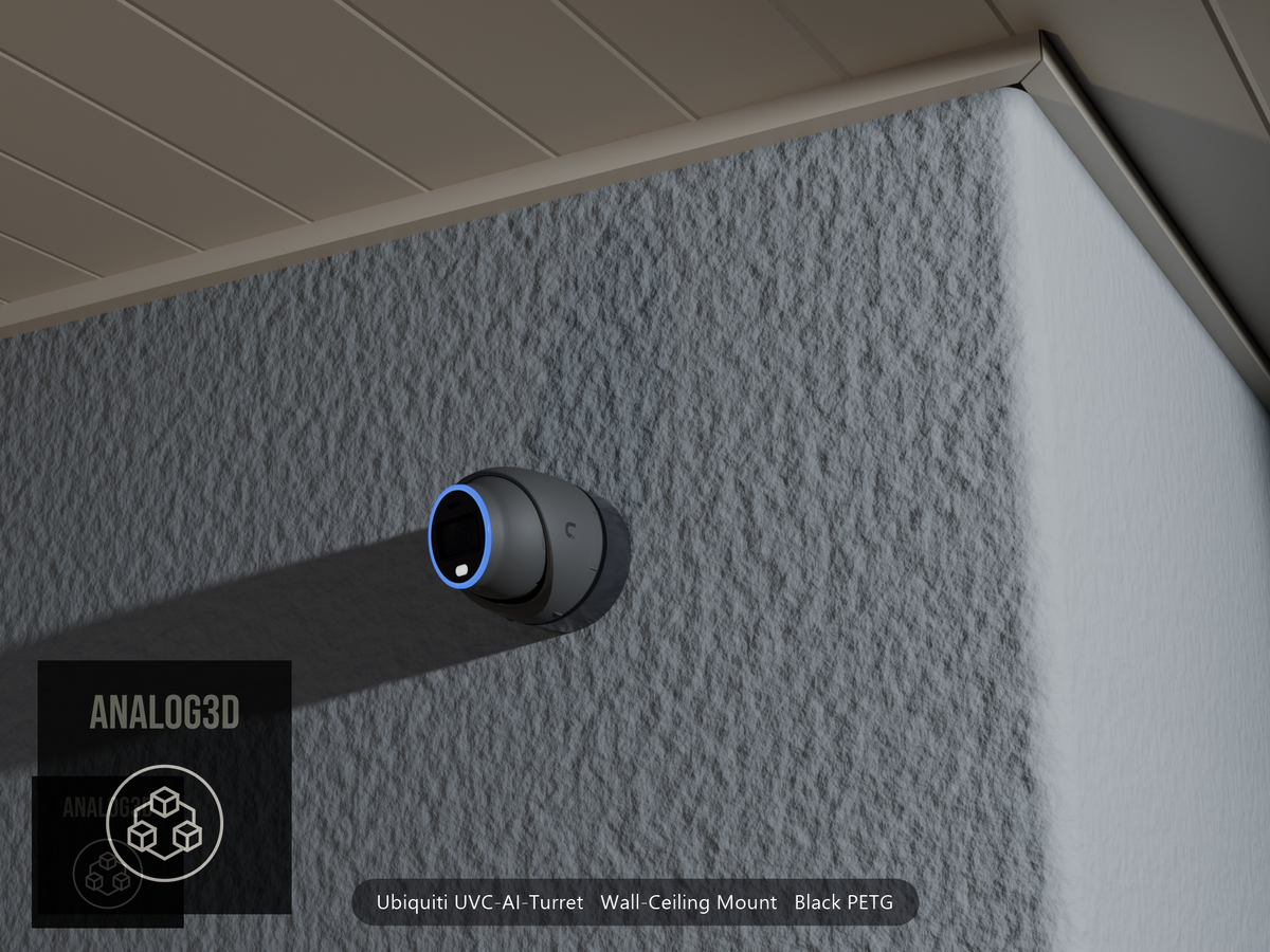 Ubiquiti UVC-AI-Turret wall mount in black PETG on a stucco wall at night