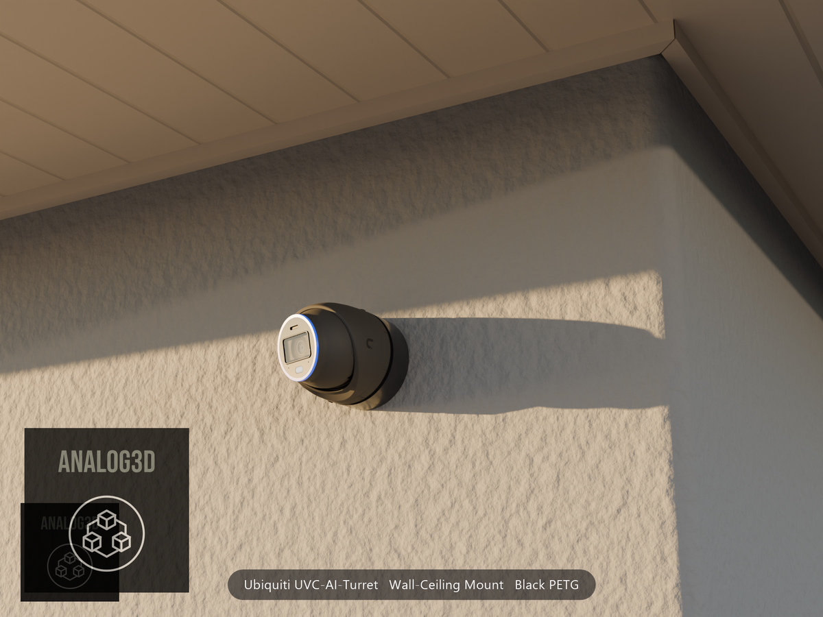 Ubiquiti UVC-AI-Turret wall mount in black PETG on a stucco wall at golden hour