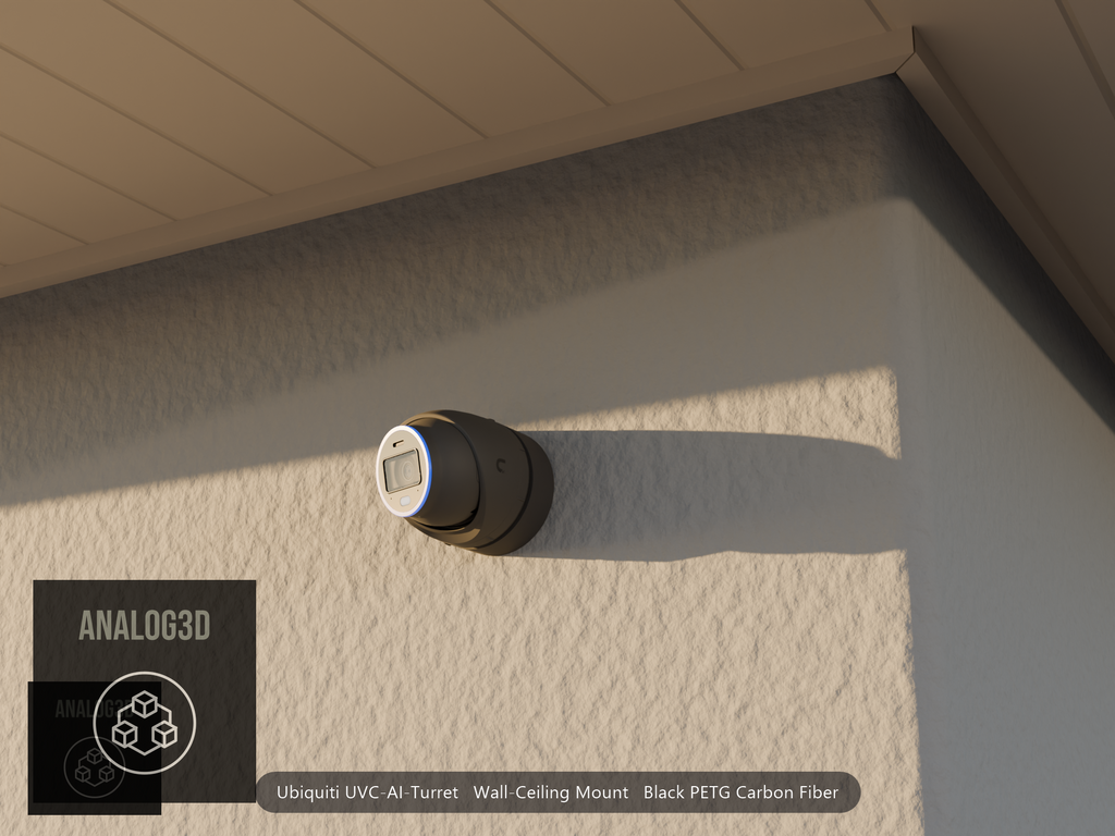 Ubiquiti UVC-AI-Turret wall mount in black PETG carbon fiber on a stucco wall at golden hour