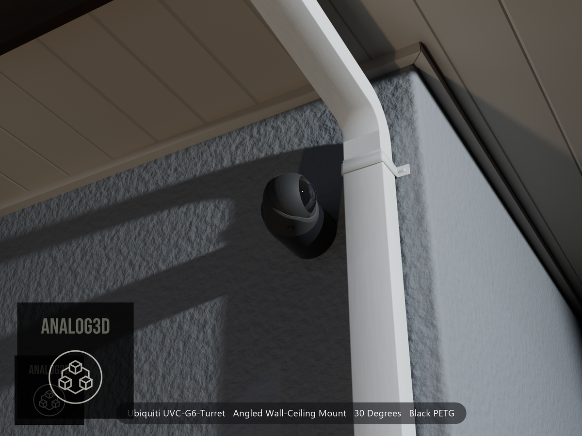 Ubiquiti UVC-G6-Turret on black PETG angled wall mount extending past a downspout on a stucco wall at night