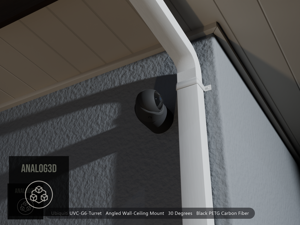 Ubiquiti UVC-G6-Turret on black PETG carbon fiber angled wall mount extending past a downspout on a stucco wall at night