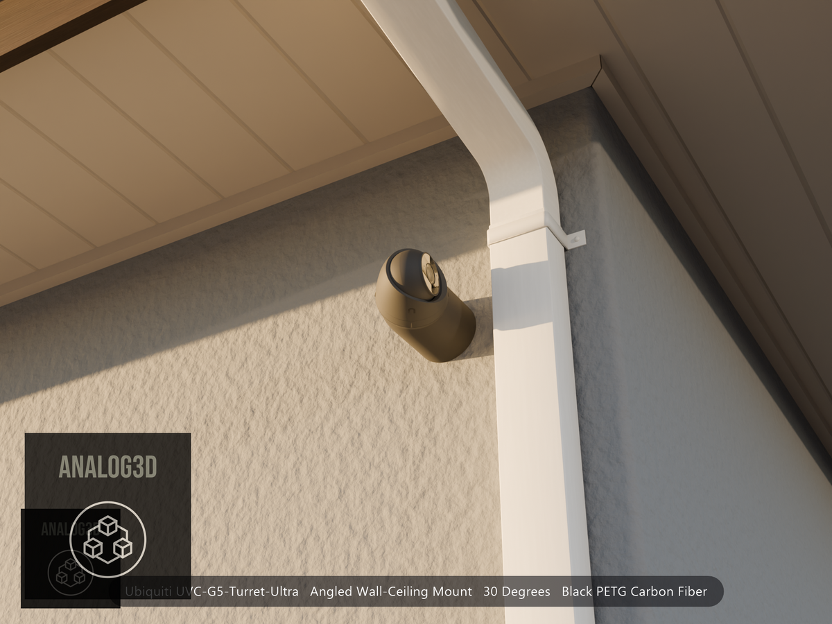 Ubiquiti UVC-G5-Turret-Ultra on black PETG carbon fiber angled wall mount extending past a downspout on a stucco wall at golden hour