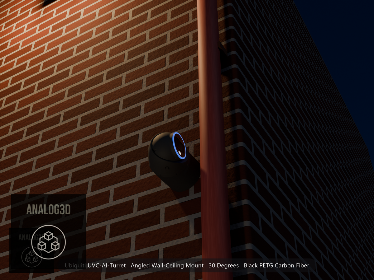 Ubiquiti UVC-AI-Turret on black PETG carbon fiber angled wall mount extending past a downspout on a brick wall at night