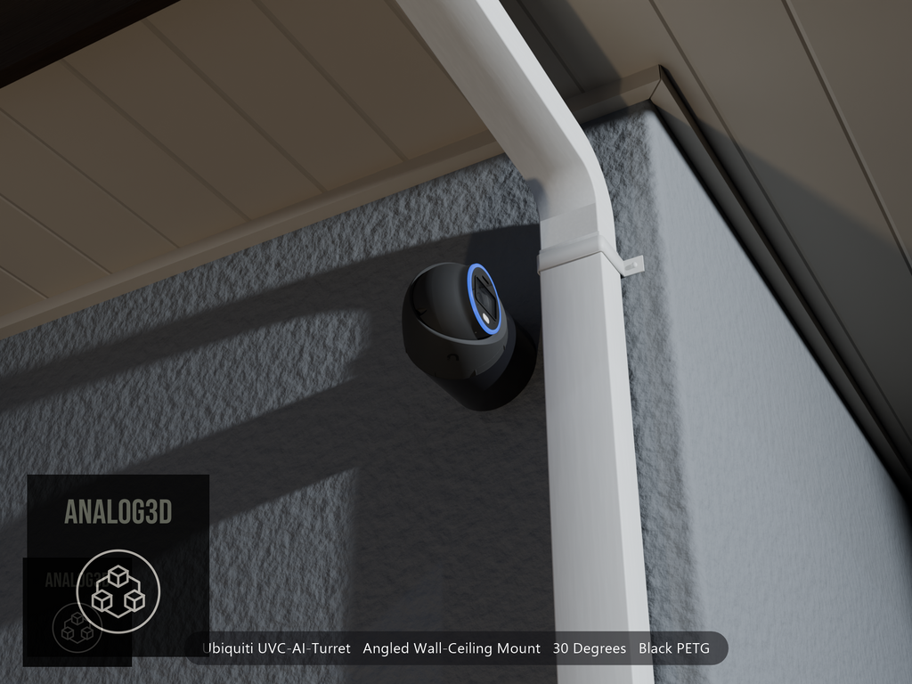 Ubiquiti UVC-AI-Turret on black PETG angled wall mount extending past a downspout on a stucco wall at night