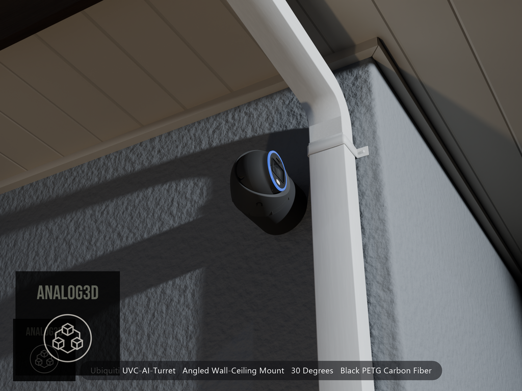 Ubiquiti UVC-AI-Turret on black PETG carbon fiber angled wall mount extending past a downspout on a stucco wall at night