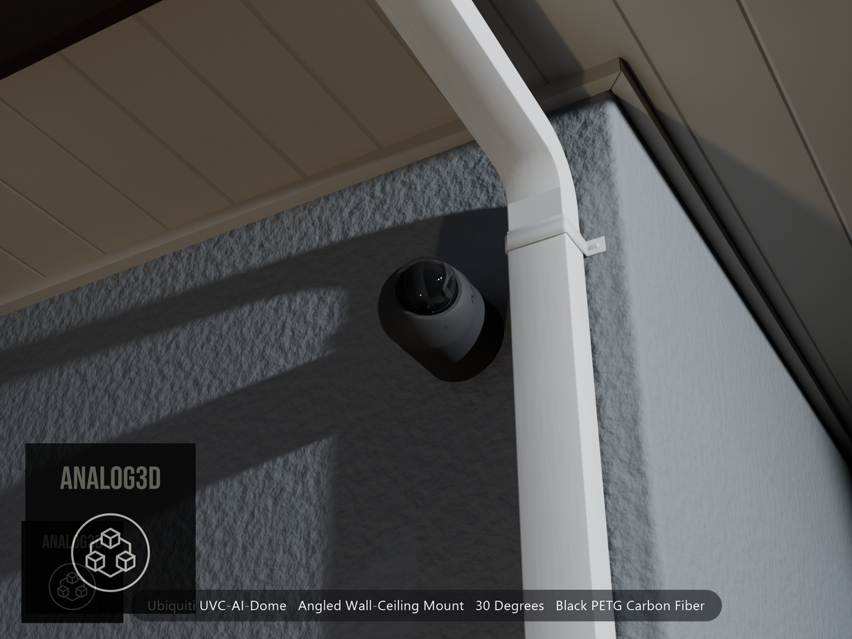 Ubiquiti UVC-AI-Dome on black PETG carbon fiber angled wall mount extending past a downspout on a stucco wall at night