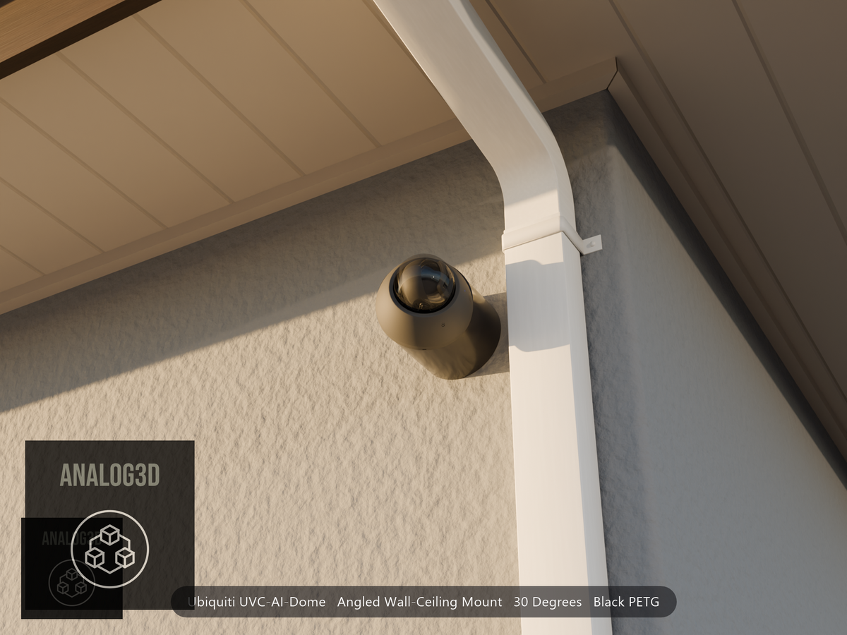 Ubiquiti UVC-AI-Dome on black PETG angled wall mount extending past a downspout on a stucco wall at golden hour