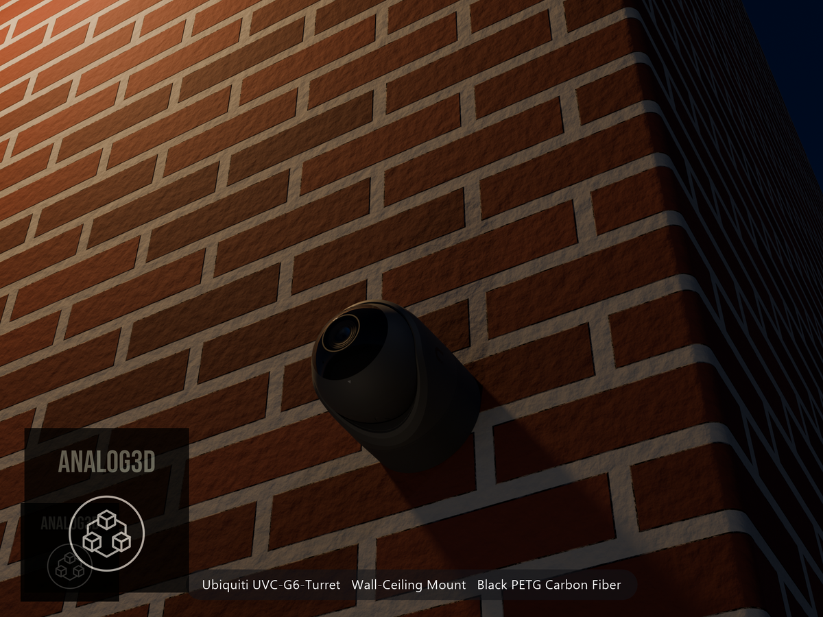 Ubiquiti UVC-G6-Turret on black PETG carbon fiber wall-ceiling mount on a brick wall at night