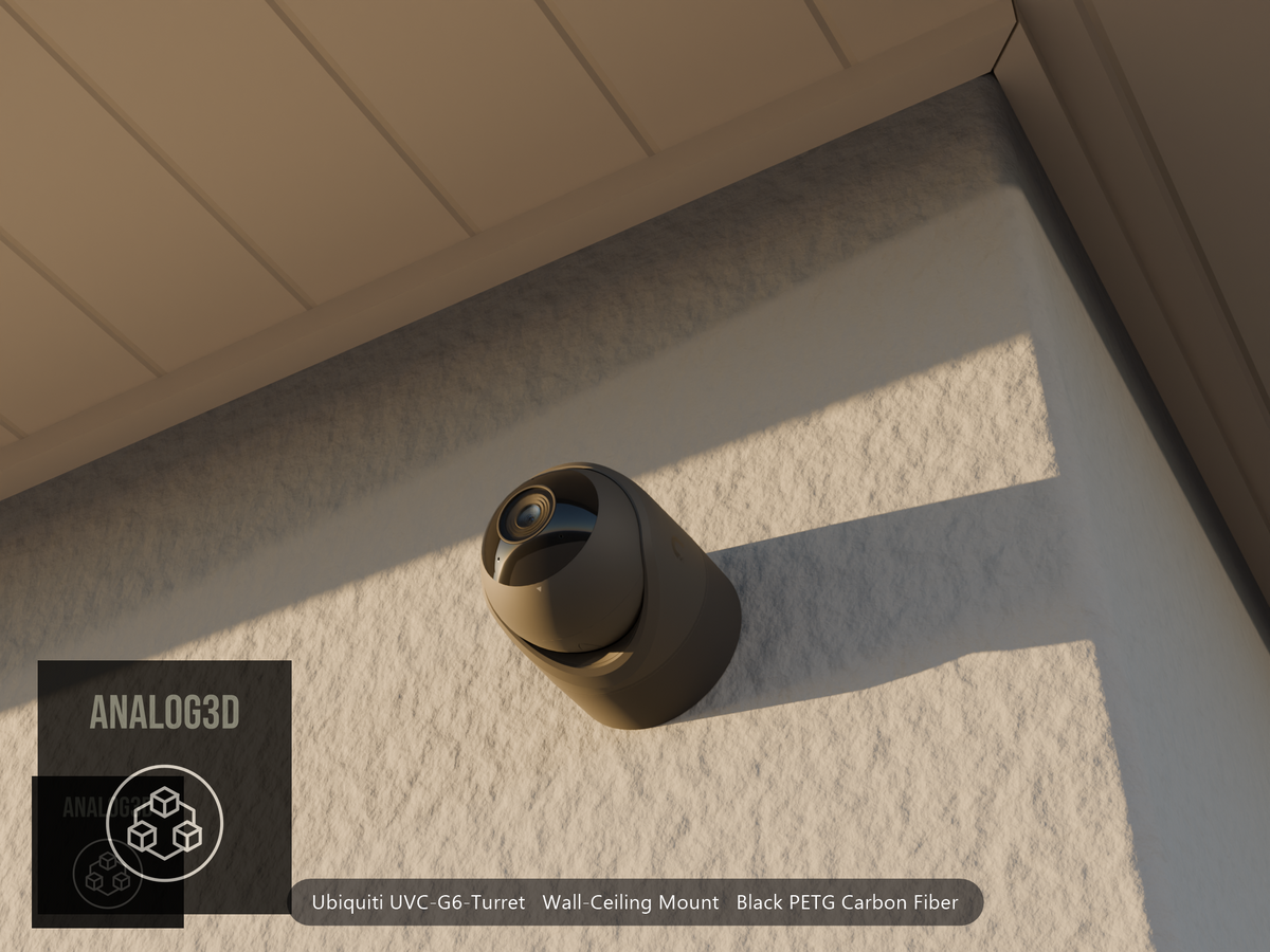 Ubiquiti UVC-G6-Turret on black PETG carbon fiber wall-ceiling mount on a stucco wall at golden hour