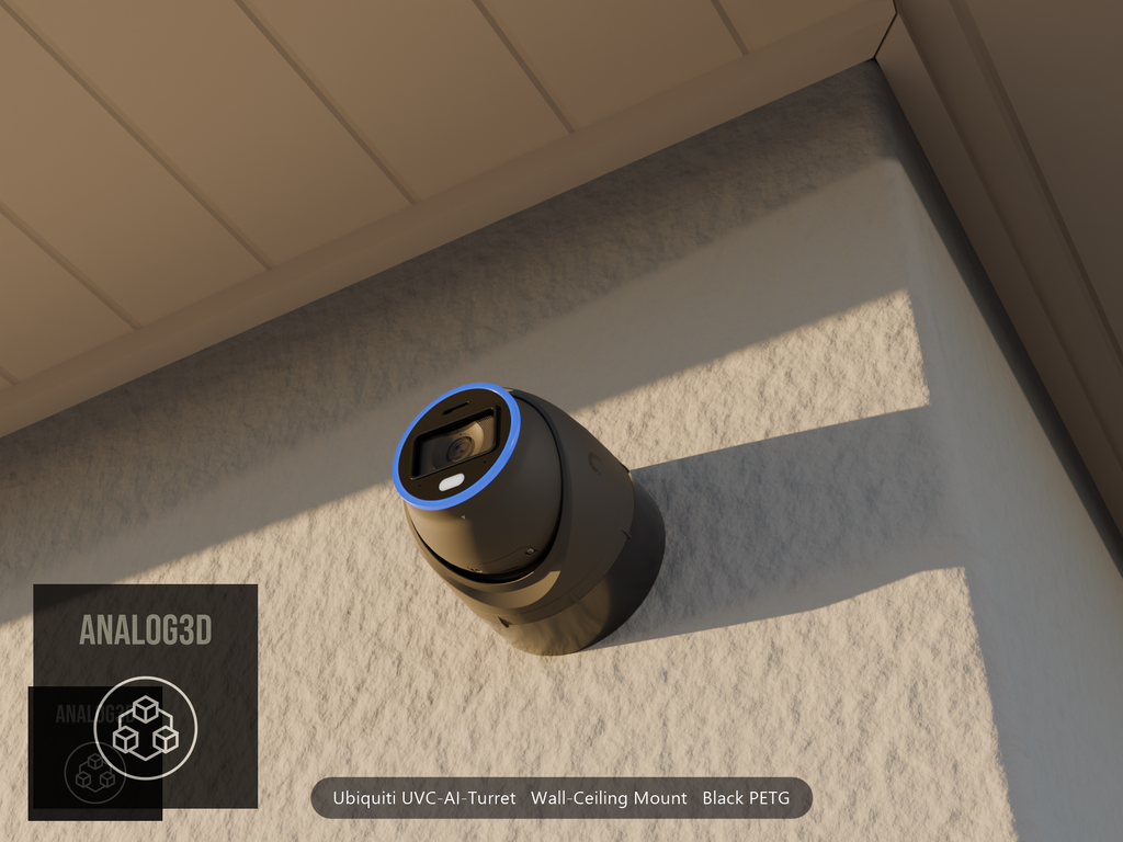 Ubiquiti UVC-AI-Turret on black PETG wall-ceiling mount on a stucco wall at golden hour