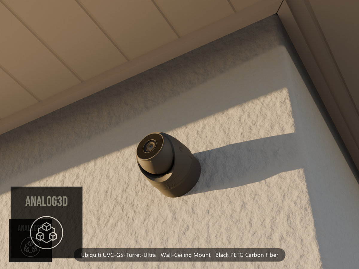 Ubiquiti UVC-G5-Turret-Ultra on black PETG carbon fiber wall-ceiling mount on a stucco wall at golden hour