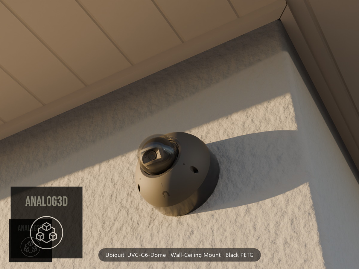 Ubiquiti UVC-G6-Dome on black PETG wall-ceiling mount on a stucco wall at golden hour