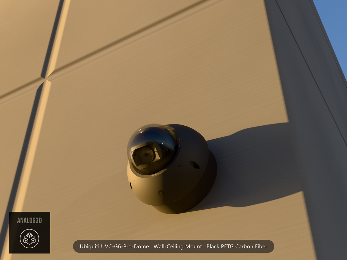 Ubiquiti UVC-G6-Pro-Dome black edition on black PETG carbon fiber wall-ceiling mount on a concrete wall at golden hour
