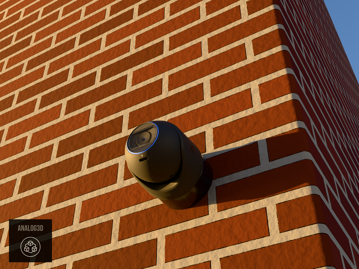 Ubiquiti UVC-G6-Pro-Turret black edition on black PETG heavy duty wall-ceiling mount on a brick wall at golden hour