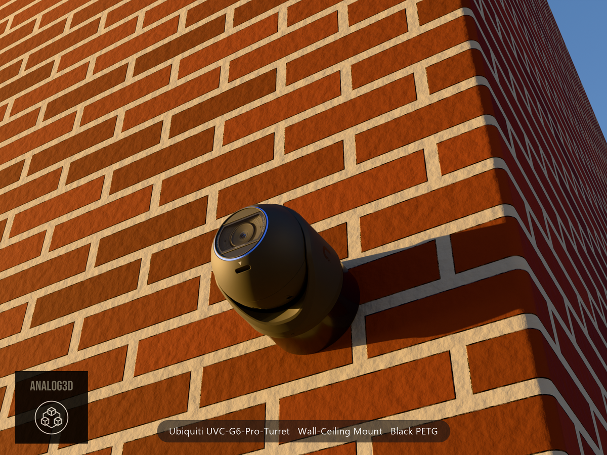 Ubiquiti UVC-G6-Pro-Turret black edition on black PETG wall-ceiling mount on a brick wall at golden hour