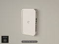 Ubiquiti UCG-Fiber in its wall mount cradle on drywall, ports to the right - White Polycarbonate