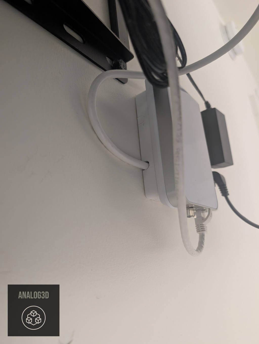 Box spacer standing a UniFi in-wall AP off the wall, cables exiting the side ports (single-gang shown)