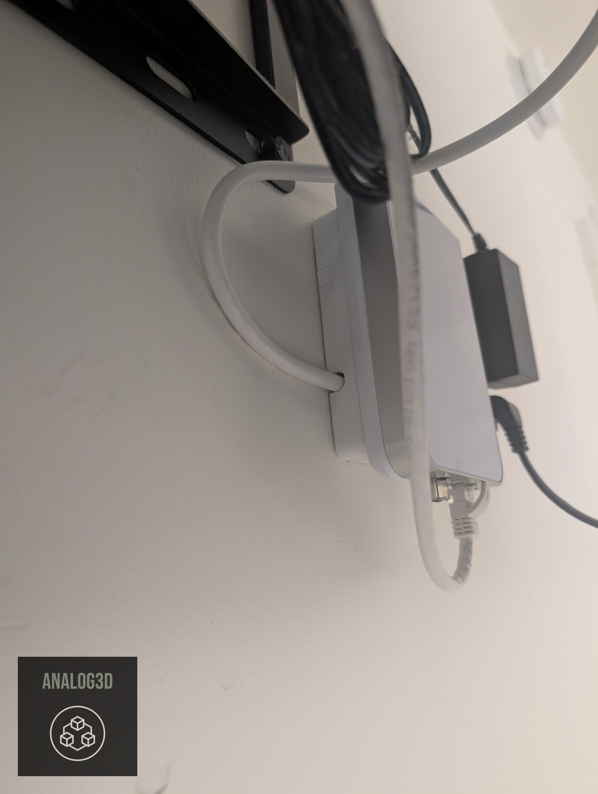 Box spacer standing a UniFi in-wall AP off the wall, cables exiting the side ports (single-gang shown)