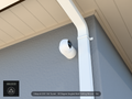 UVC-G6-Turret 30 degree angled wall-ceiling mount (3in ext3) clearing a swan-neck downspout on stucco