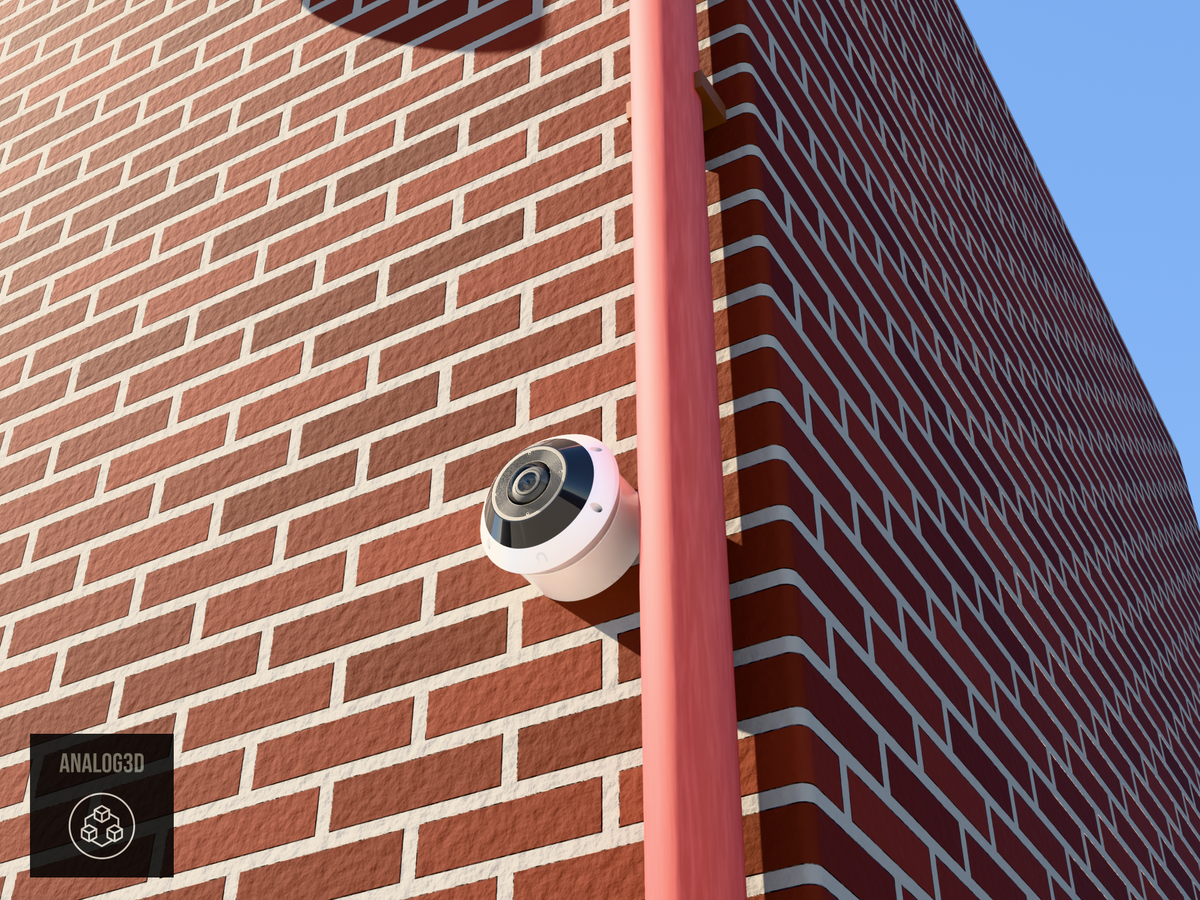 UniFi G6 Pro 360 wall-ceiling mount installed on a brick wall beside a drain pipe, White PETG, daylight