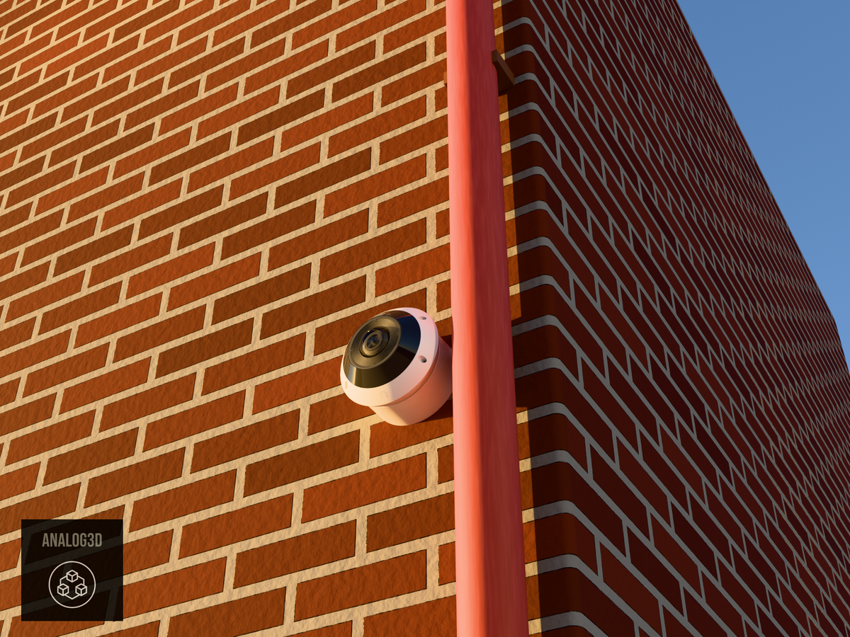 UniFi G6 Pro 360 wall-ceiling mount installed on a brick wall beside a drain pipe, White PETG, golden hour