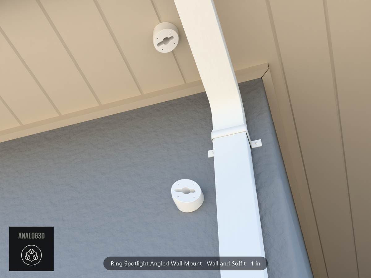 Ring Spotlight angled wall mount installed on a stucco wall beside a downspout, with a second mount hung from the soffit
