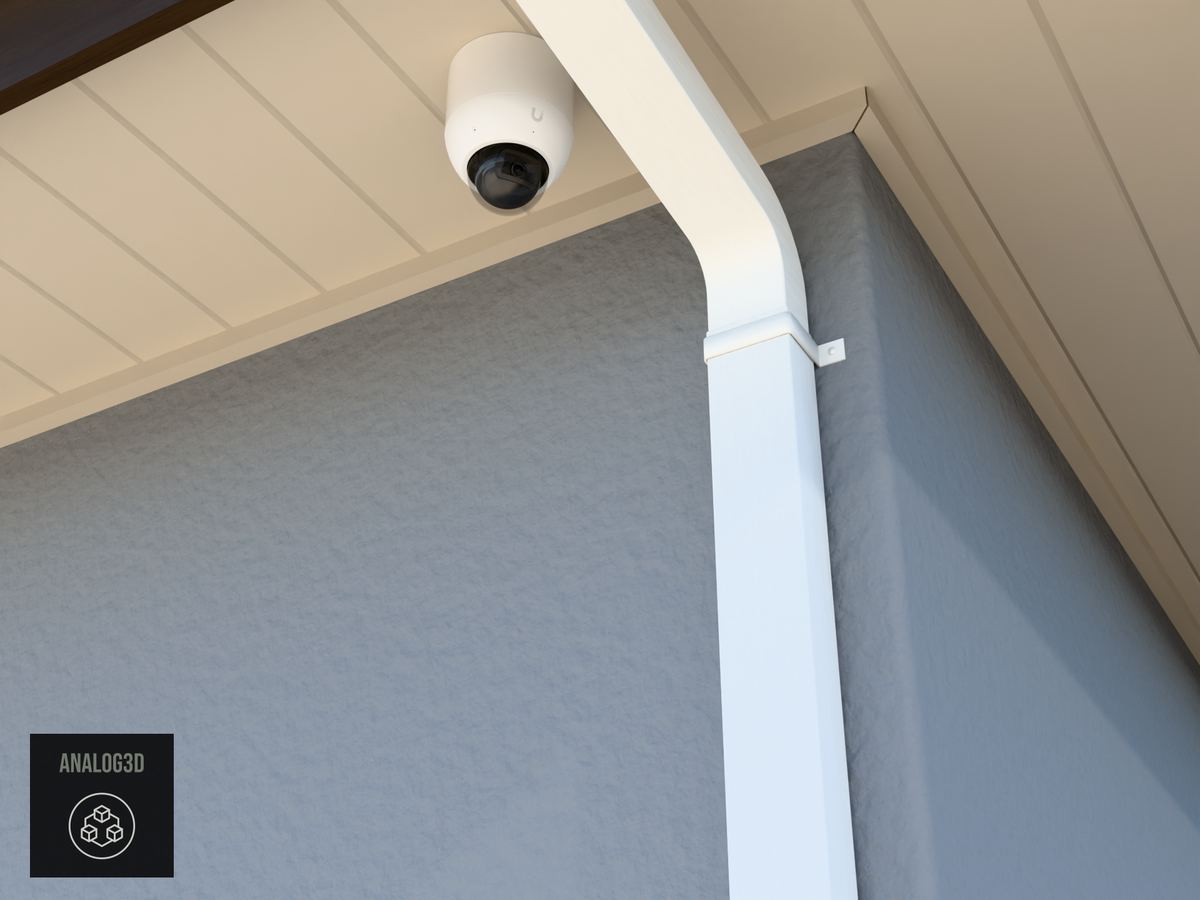UVC-AI-Dome wall-ceiling mount (3in ext3) hung from the soffit beside a swan-neck downspout